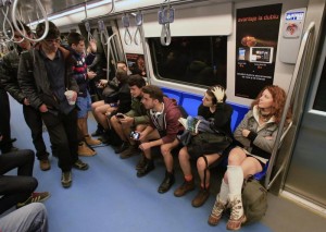 People walk inside a subway train as passengers without pants sit during "The No Pants Subway Ride" in Bucharest