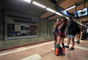 Passengers without pants wait for the subway train during "The No Pants Subway Ride" in Bucharest