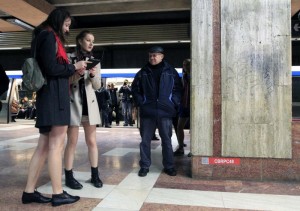 A man looks on at two passengers without pants during "The No Pants Subway Ride" in Bucharest