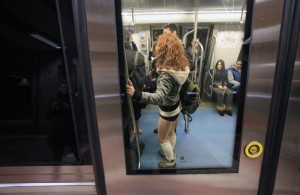 A passenger without pants stands inside a subway train during "The No Pants Subway Ride" in Bucharest