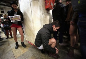 A participant takes his pants off as he prepares for "The No Pants Subway Ride" in Bucharest