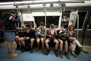 A passenger without pants sits inside a subway train during "The No Pants Subway Ride" in Bucharest