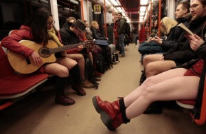 Passengers not wearing pants sit on a subway train during the "No Pants Subway Ride" in Prague