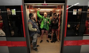 Passengers not wearing pants stand in a subway train during the "No Pants Subway Ride" in Prague