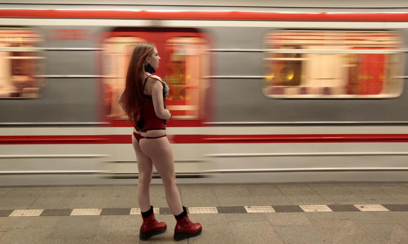 A passenger not wearing pants waits for a subway train during the "No Pants Subway Ride" in Prague