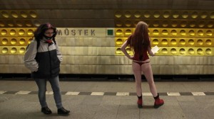 A passenger not wearing pants waits for a subway train during the "No Pants Subway Ride" in Prague