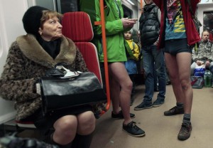 Passengers not wearing pants stand in a subway train during the "No Pants Subway Ride" in Prague