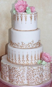 White-and-gold-wedding-cake-with-pink-flowers-612x1024